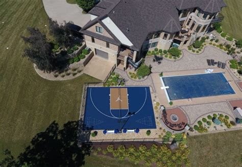 An Aerial View Of A Large House With A Basketball Court In The Middle Of It