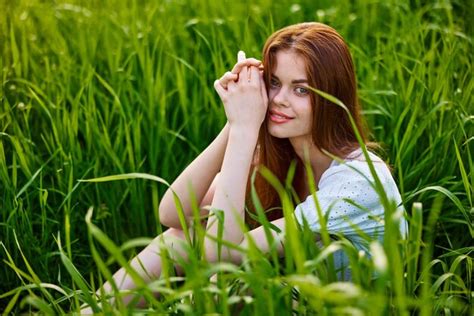 Premium Photo Side View Of Young Woman Sitting On Grass