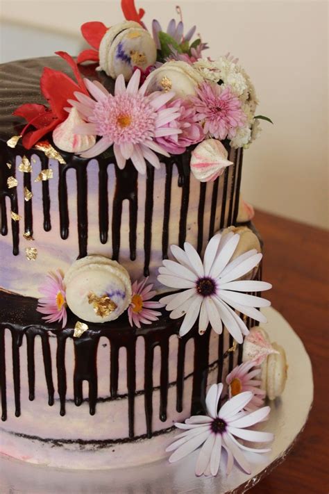 Chocolate Drip Cake In Pinks And Purple Decorated With Fresh Flowers