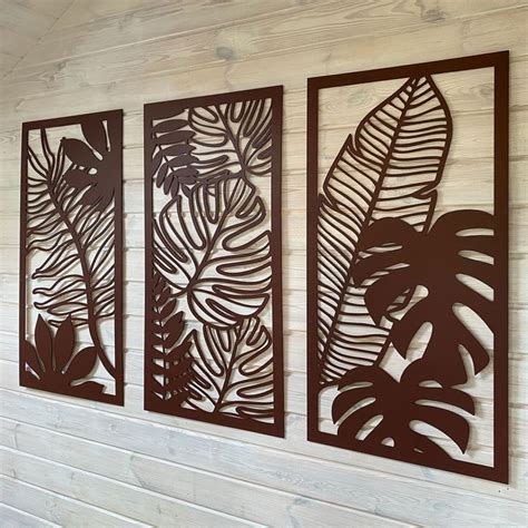 Three Metal Wall Art Panels With Leaves On Them