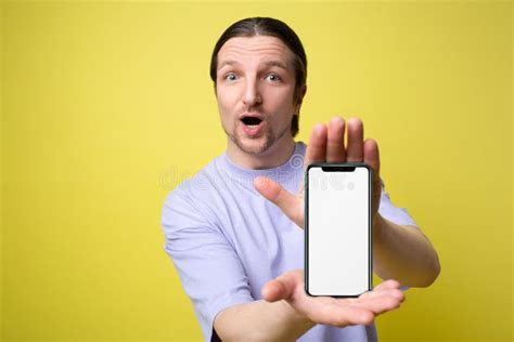 Excited Man Holding Big Smartphone With White Blank Screen In Hand