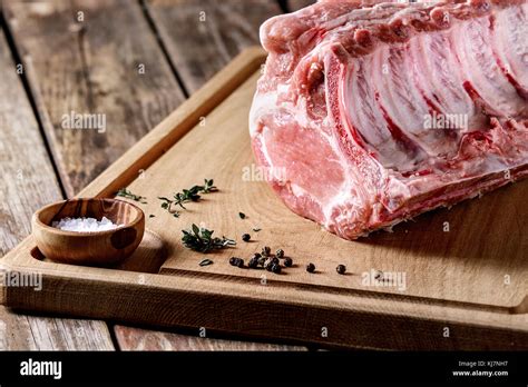 Fresh Raw Uncooked Whole Rack Of Pork Loin With Ribs On Wooden Cutting