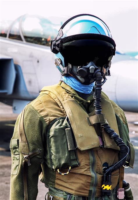 Premium Photo | Fighter pilot helmet and suit in front of fighter jet