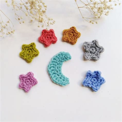 Six Crocheted Stars Are Arranged On A White Surface