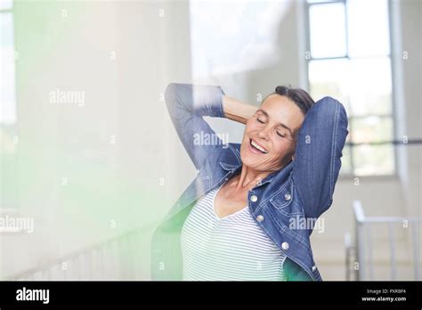 Portrait Of Smiling Mature Woman Wearing Denim Shirt Stock Photo Alamy