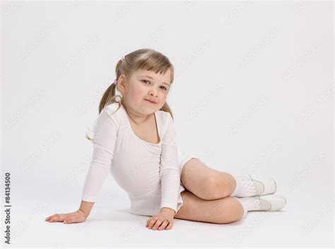 Pretty little girl sitting on the floor Stock Photo | Adobe Stock