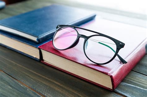 Premium Photo Reading Glasses Put On Hardcover Books Over Wooden Table