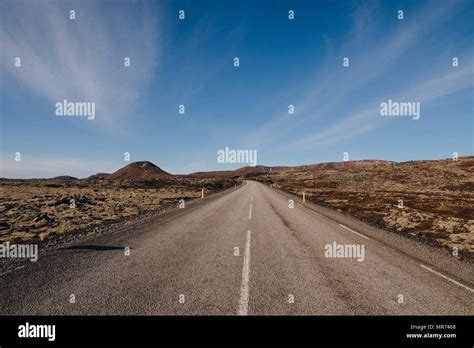 Empty Asphalt Road In Majestic Icelandic Landscape At Sunny Day