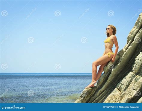 Blonde Posing Leaning Against Rock Near Ocean Coast Stock Image Image