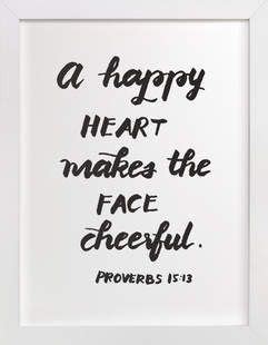 A White Frame With Black Lettering That Says A Happy Heart Makes The