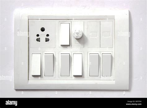 White Electrical Switch Board Panel On White Concrete Wall Stock Photo