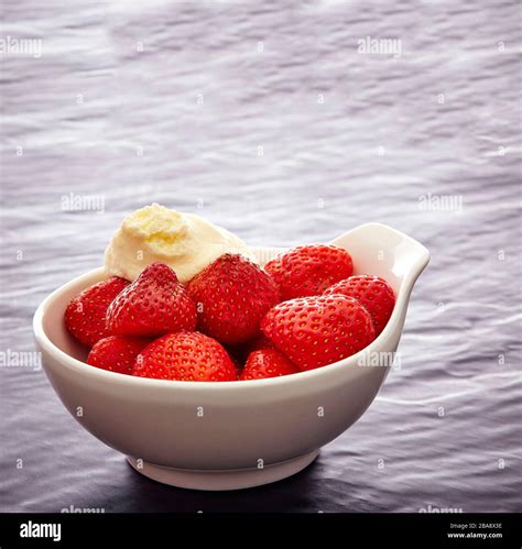 Shot Of A Bowl Of Strawberries With Cottage Cheese Stock Photo Alamy