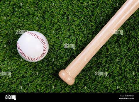 Photo Of A Baseball And Wodden Bat On Grass Stock Photo Alamy