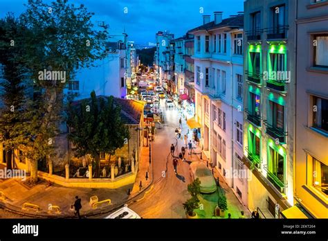 Night View From A Upper Level Window Overlooking A Busy Street In