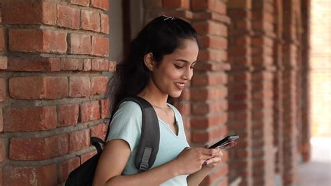 Video Clip Of A Side View Of A Female College Student Typing Text On