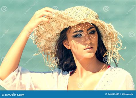 Portrait Of Beautiful Young Woman Wearing Summer Hat At Beach Closeup