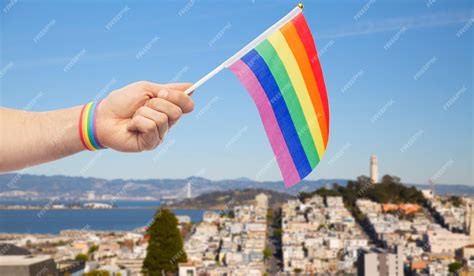 Premium Photo Hand With Gay Pride Rainbow Flag And Wristband