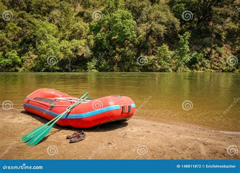 Whitewater Rafting Boat On Shore Of Mountain River Ready For Adventure