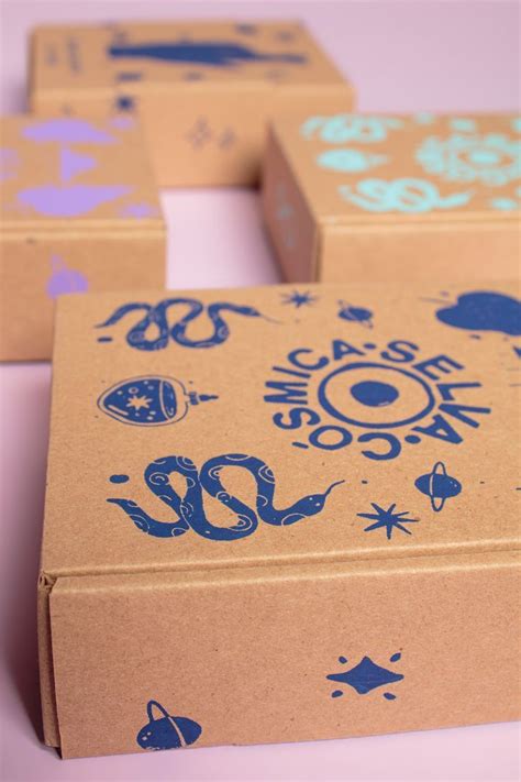 Three Cardboard Boxes With Designs On Them Sitting On A Table