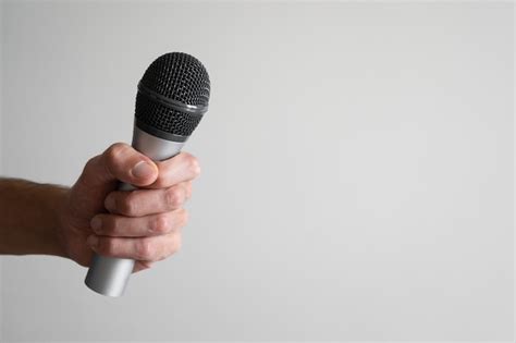 Premium Photo Hand Holding A Silver Microphone On The Left Side Of