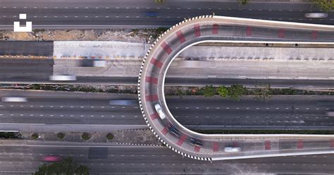 An Aerial View Of A Highway With A Curved Road Photo Free Road Image