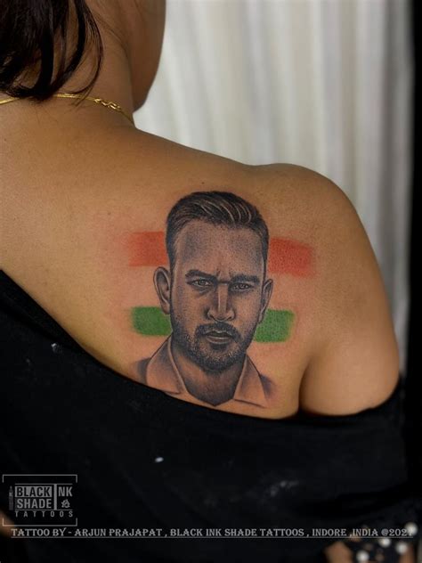 a woman with a tattoo on her shoulder has a drawing of a man's face