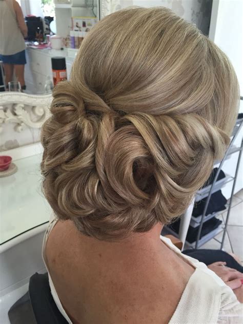 A Woman Is Getting Her Hair Done At The Salon