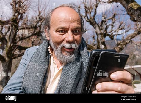 Portrait Of A Confident Handsome Mature Man Pensioner Grandfather In The Small Town Stock
