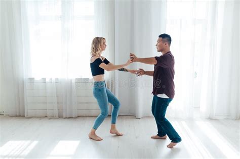 A Man And A Woman Dance In The Hall Of The Latin Bachata Studio Stock