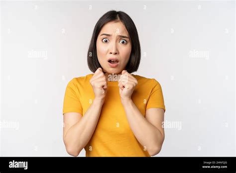 Portrait Of Scared Asian Woman Shaking From Fear Looking Terrified And