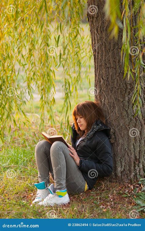 Pretty Teenage Girl Reads Book Under The Tree Stock Photo Image Of