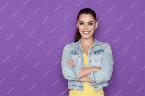 Premium Ai Image Smiling Woman In Jeans Jacket Is Posing With Arms