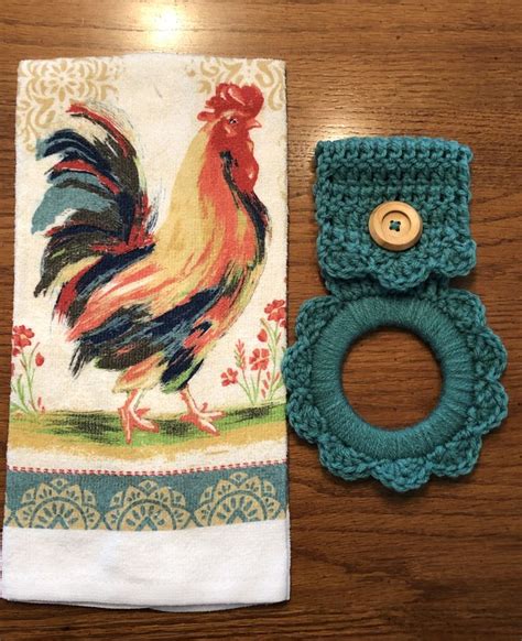 A Napkin With A Ring On It Sitting Next To A Rooster Towel Holder And