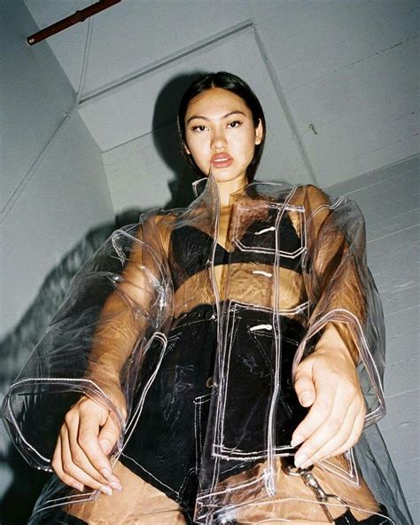 A Woman Sitting On Top Of A Chair Covered In Plastic Covering Her Body