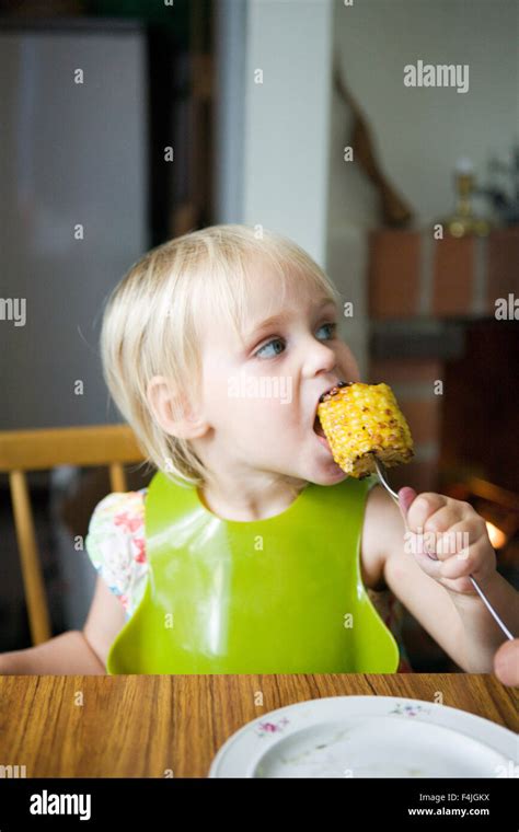 Girl Eating Corn Stock Photo Alamy