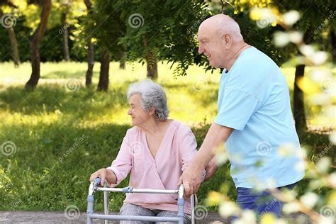 Elderly Man Helping His Wife With Walking Frame Stock Image Image Of