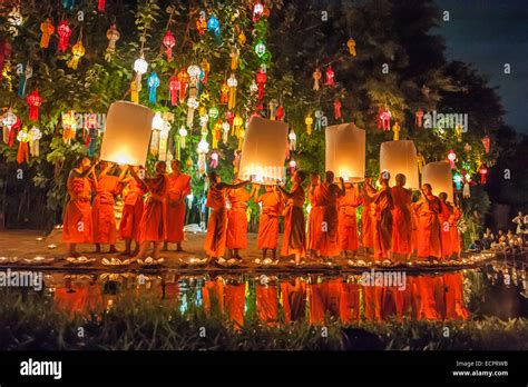 Buddhist Monks Releasing Chinese Paper Lanterns At The Loy Krathong