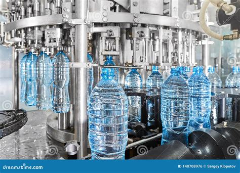 Modern Automated Mineral Water Bottling Line At The Plant Stock Photo