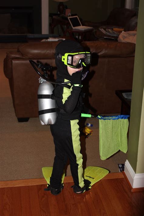 a little boy dressed in a costume and goggles