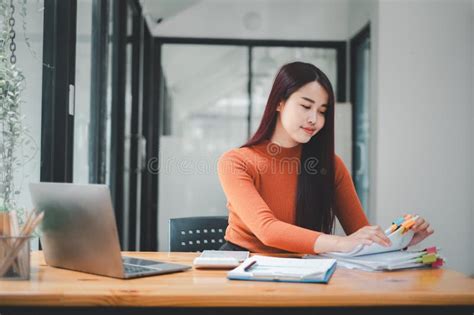 Businesswoman Working In Stacks Of Paper Files For Searching And