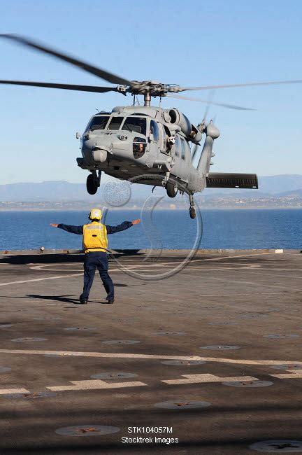 Boatswain S Mate Directs An MH 60S Sea Hawk Helicopter On The Flight