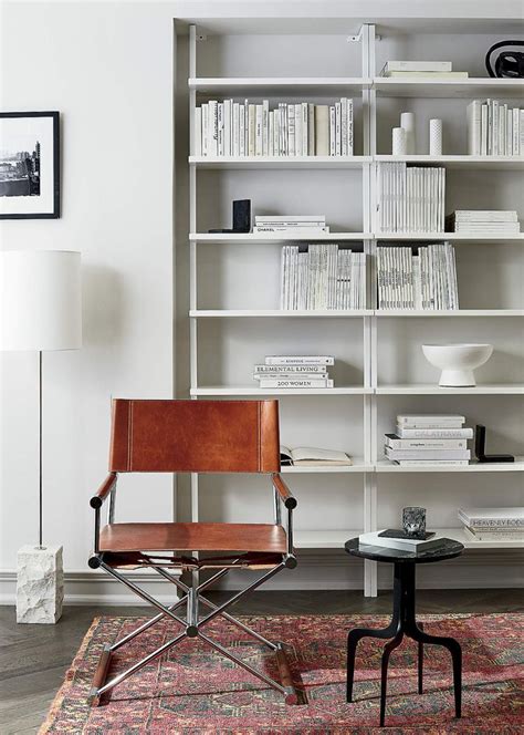 A Chair And Table In Front Of A Bookshelf