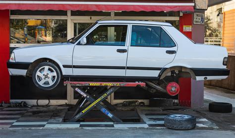 Antalya Turkey March 04 2022 yellow Tofas Dogan car on a lift at a tire ...