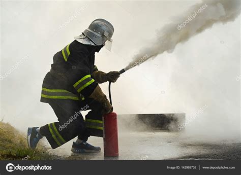 Firefighter Using Fire Extinguisher — Stock Photo © Vaksmanv101 142989735