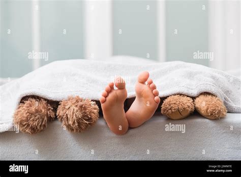 Sleeping couple barefoot lying bed hi-res stock photography and images - Alamy