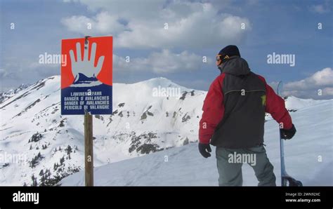 A Danger Of Avalanches Warning Sign On A Snowy Ski Area Danger Of