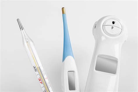 Three types of thermometers for measuring body temperature in a patient on a white background ...