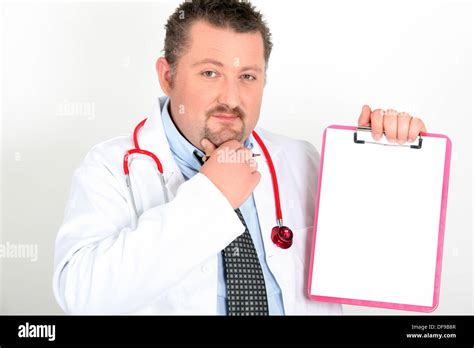 Confused Male Doctor Holding Clipboard Stock Photo Alamy