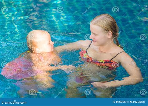 Mother And Daughter Having Fun In Pool At Tropical Beach Resort Stock