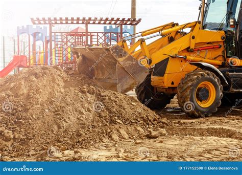 Excavator Digger Machine Digging Earth In Construction Site Stock